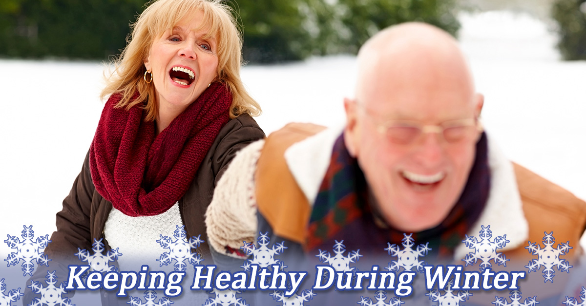 Keeping Healthy During Winter. Senior couple playing in the snow.