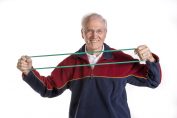 Arthritis and Physical Activity, Picture of elderly Caucasian male using stretch band