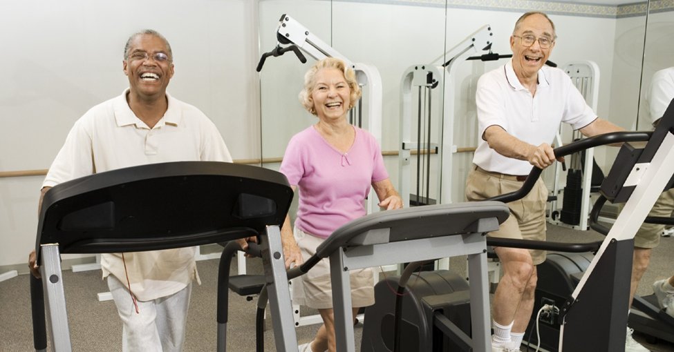 Is Sitting Too Much Bad for Your Brain? Picture of 3 seniors, a black male, a caucasian female and a caucasian male all walking on treadmills.