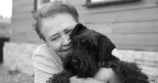 Pet Ownership and Effect on Mental Health in Seniors. Picture of an elderly caucasian female hugging a small black dog.