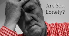 Social Isolation Causes Health Effects for Seniors. Picture of a caucasian male holding onto his head as if in frustration or sadness.