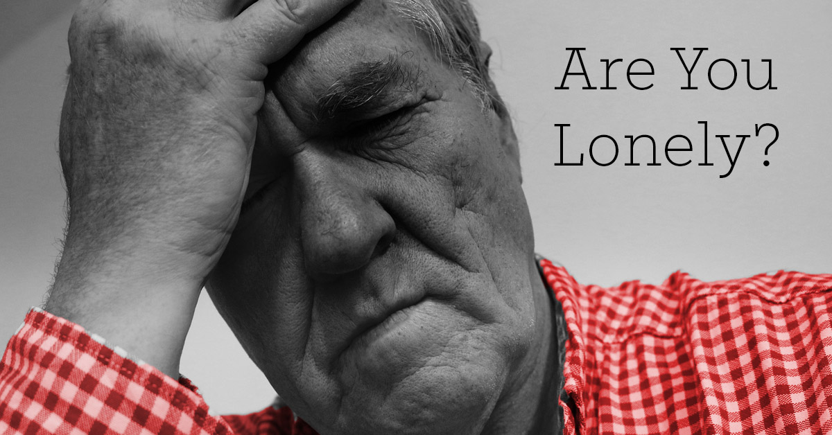Social Isolation Causes Health Effects for Seniors. Picture of a caucasian male holding onto his head as if in frustration or sadness.