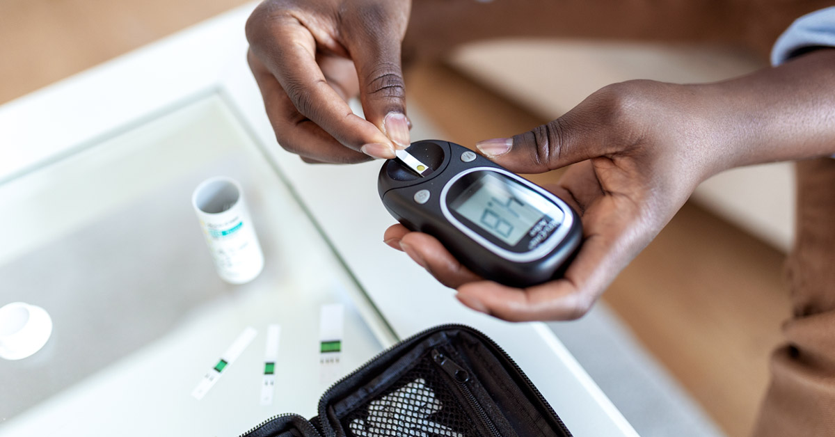 Image of someone using a blood sugar tester